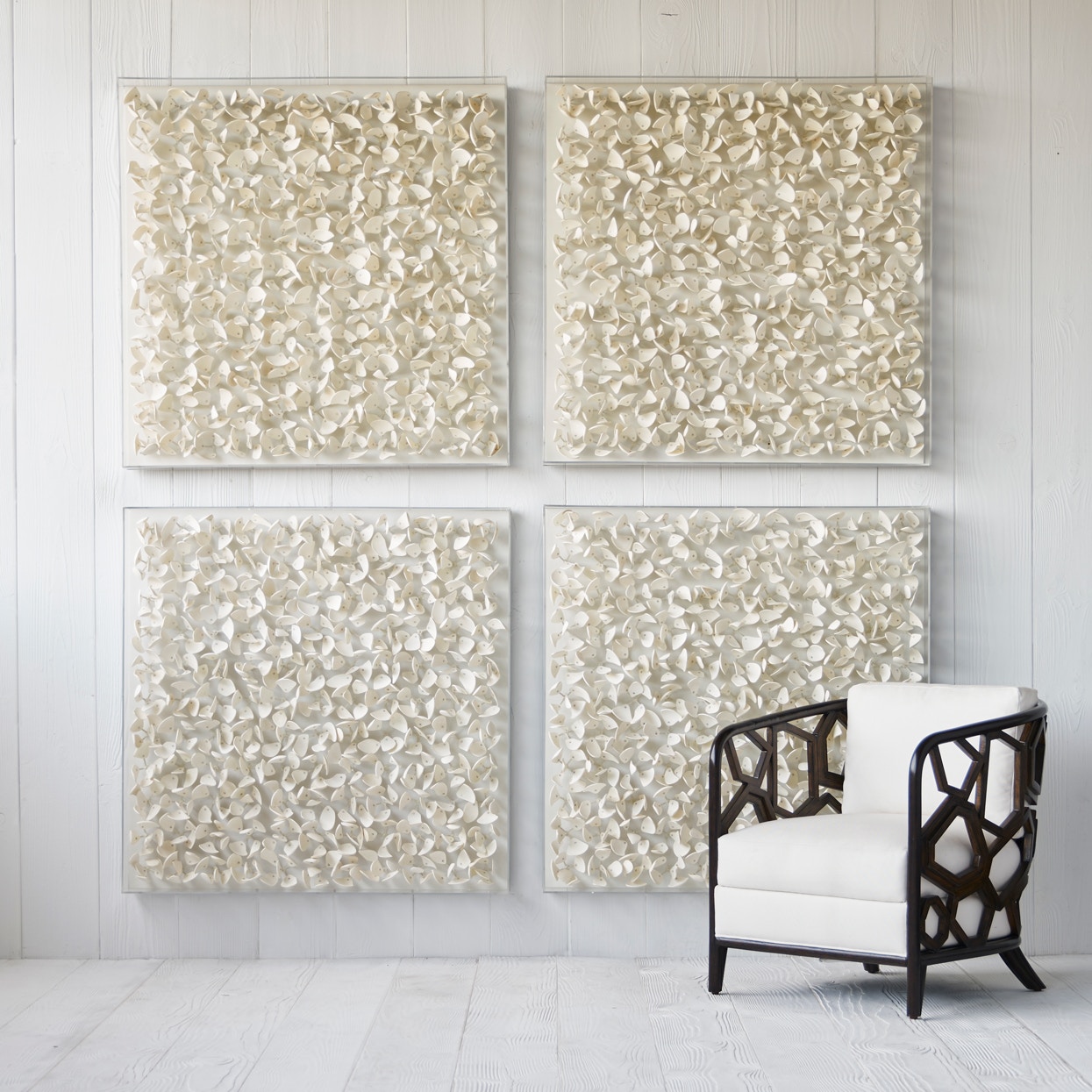 Hand-cut coco wood in petal forms in off-white finish with a clear