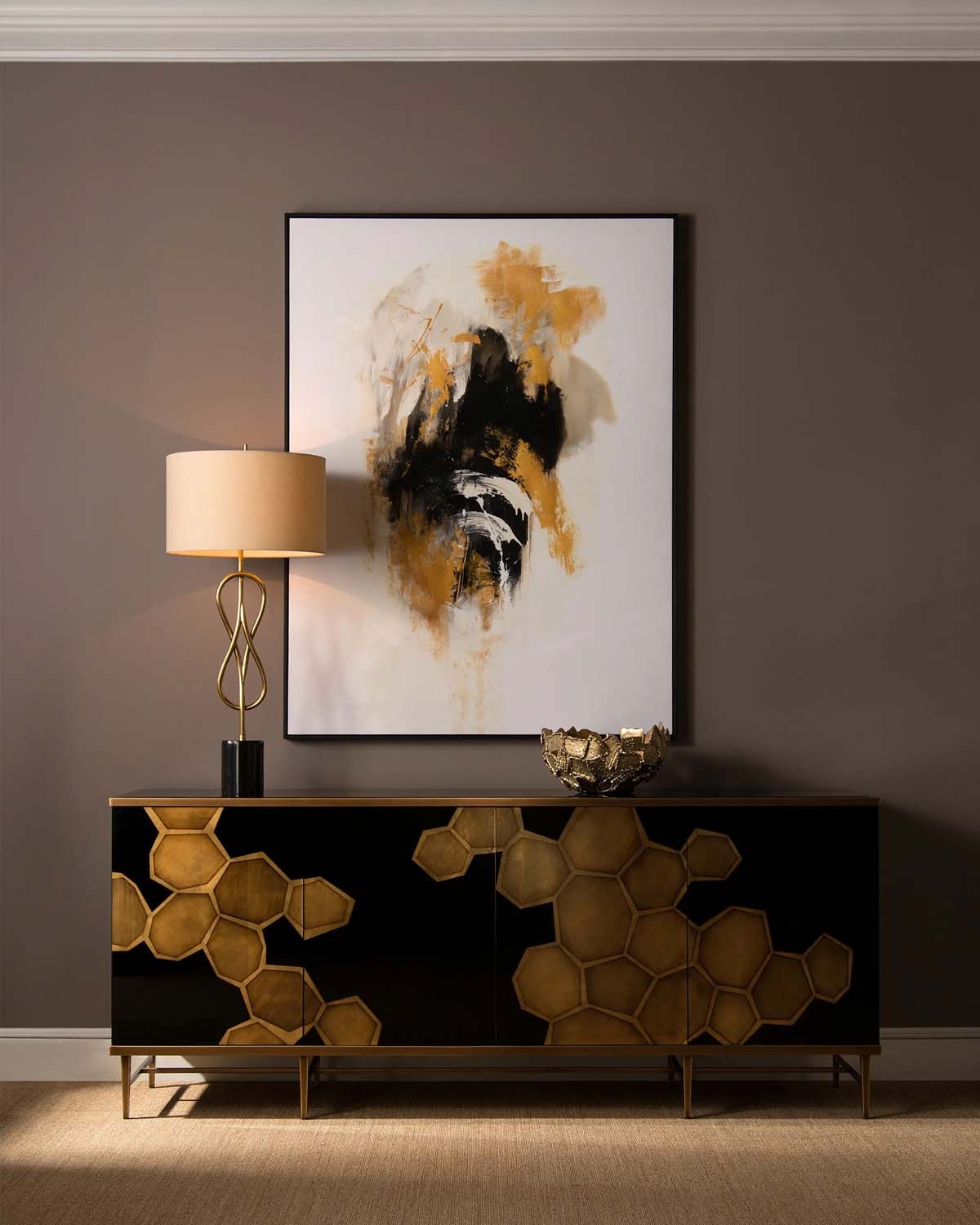  Honeycomb credenza has inset black glass panels with gold framing. 17